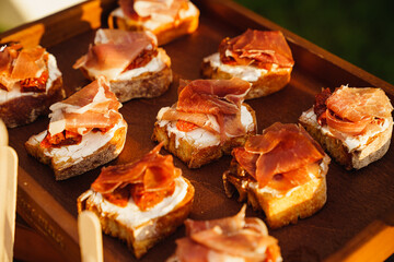canapes with sauce and meat for the buffet. catering for a dinner party.