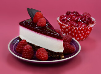 Slice of delicious creamy raspberry cake with jelly topping and raspberries stock images. Slice of cheesecake with raspberries isolated on a pink background stock photo