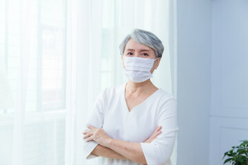 Asian senior woman suffer from cough with face mask protection