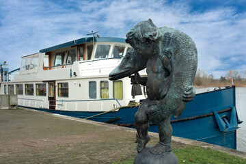 Boy with the fish at the IJsselkade in Kampen, Overijssel province, The Netherlands - obrazy, fototapety, plakaty