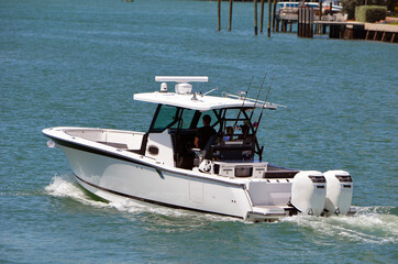 Opem sport fishing boat with covered center console.