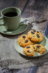 Fresh baked homemade oatmeal cookies with raisins and sunflower seeds on wooden background