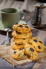 Fresh baked homemade oatmeal cookies with raisins and sunflower seeds on wooden background