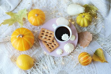 Cup of coffee, meringue, pumpkin, leaves, warm blanket, the concept of home comfort, relaxation, loneliness, Thanksgiving, autumn season