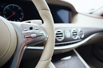 Fototapeta na wymiar Control buttons on steering wheel. Car interior.