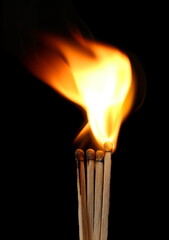 Match stick ignited burning bright big fire flame isolated on black background, clipping path