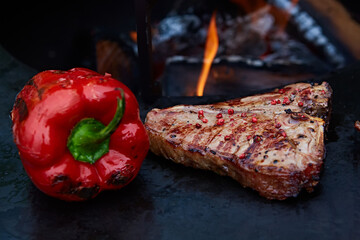 Grilled T-Bone Steak on serving board on wooden background