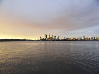 Skyline of a big city, its river and its skyscrapers during the sunset. Perth and the Swan River, Australia. View from Victoria Park.