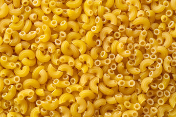 Close up uncooked elbow macaroni for background.Top view