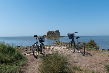 Fototapeta premium bicycles next to a ruins in the sea