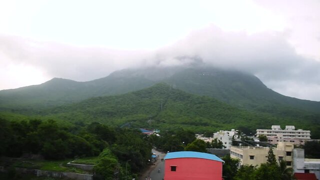 Beautiful view of Girnar mountain with green trees and top of mountain covered with clouds during monsoon season. At Junagadh, Gujarat, India