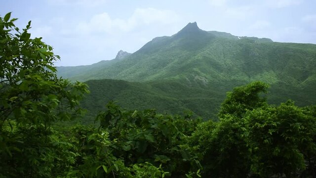View of stairs of Green mountains and beautiful sky with clouds at Girnar hills, Gujarat, India.