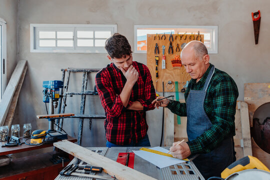 father and son in their carpentry workshop