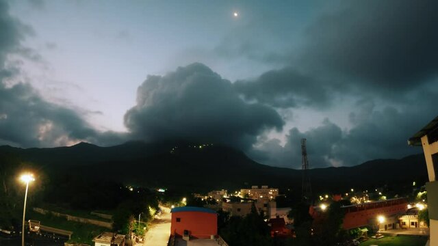 Night to Day Sunrise Time Lapse In The Girnar Hills 4K. Monsoon clouds rolling over mountain cliff. Junagadh, Gujarat, India