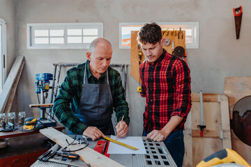 father and son in their carpentry workshop