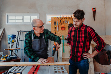 father and son in their carpentry workshop