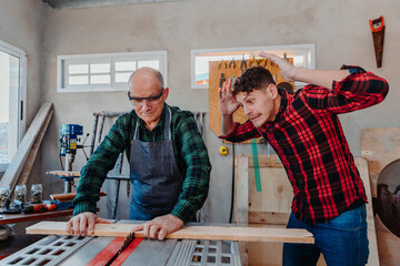 father and son in their carpentry workshop, danger, misuse of tools