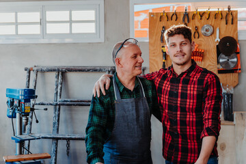 father and son in their carpentry workshop