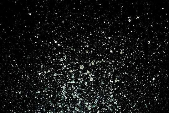 Explosion of water drops on black background. Studio shot