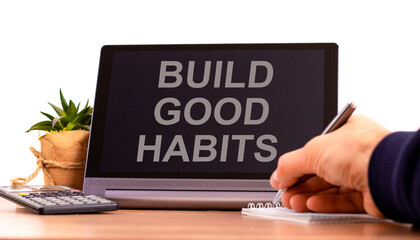 Build good habits symbol. Tablet with words 'build good habits'. Businessman hand with pen, house plant. Beautiful white background. Business, psychology and build good habits concept, copy space.