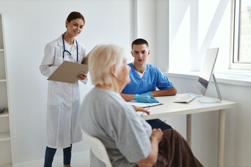 doctor and nurse examining an elderly woman health diagnosis