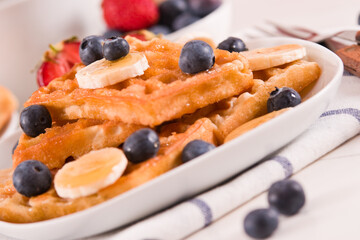 Waffles with blueberries, bananas and honey.