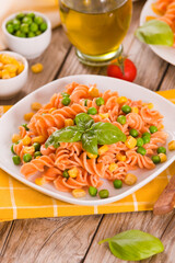 Fusilli pasta with peas and sweet corn.
