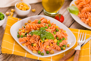 Fusilli pasta with peas and sweet corn.