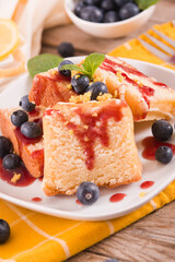 Lemon pund cake with blueberries and strawberry syrup.
