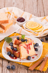 Lemon pund cake with blueberries and strawberry syrup.