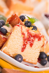 Lemon pund cake with blueberries and strawberry syrup.