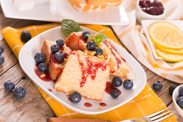 Lemon pund cake with blueberries and strawberry syrup.