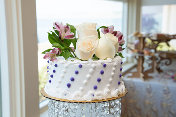 wedding cake with white roses on top