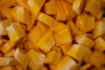 Beautiful fall background. Ripe pumpkin, chopped and diced