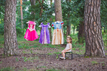 Charming baby hung out princess costumes to dry