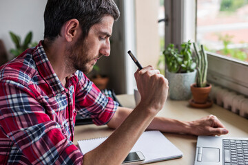 Man writing down business ideas at desk