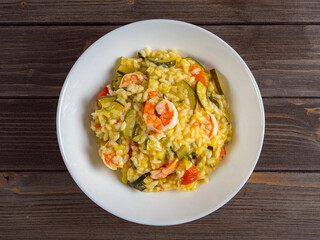 risotto with shrimp and zucchini, recipe made from rice and seafood, still life of food top view flat lay