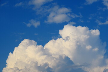 Naklejka na ściany i meble Big white fluffy cloud and blue sky