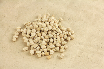 Fototapeta na wymiar heap of dried chickpeas on craft paper, chickpea seeds are high in vegetable protein