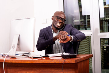 Fototapeta premium late businessman talking on phone and looking at the time on his wrist watch in the office.