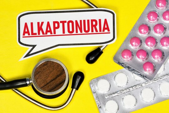 Alkaptonuria. The inscription of a medical diagnosis, against the background of a stethoscope and medicines.
