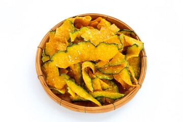 Green pumpkin slice chips in bamboo basket on white background.