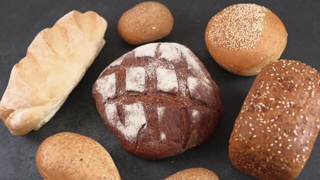 Different kinds of delicious fresh homemade bread loaves and a bun