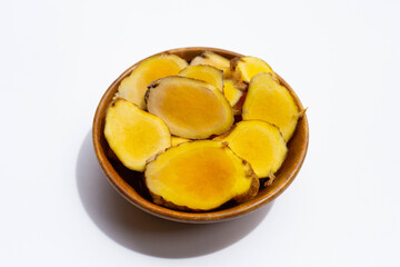 Phlai slices, Cassumumr ginger or zingiber montanum in wooden bowl on white background.