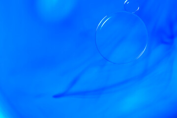Abstract Macro Photography of a bubble on a blue colour water mixed with blue food color mix. Macro bubble photography.