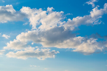 Fototapeta na wymiar White heavy cloud against blue summer sky