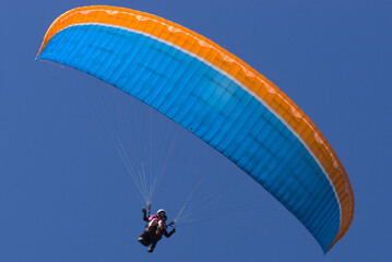 Tandem blue and orange paragliding flight, first flight