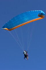 Tandem blue and orange paragliding flight, first flight