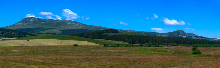 Fototapeta na wymiar Panoramic view of the Sancy Puys Chain in summer. Auvergne, France