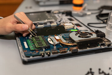 technician fixing a damaged laptop